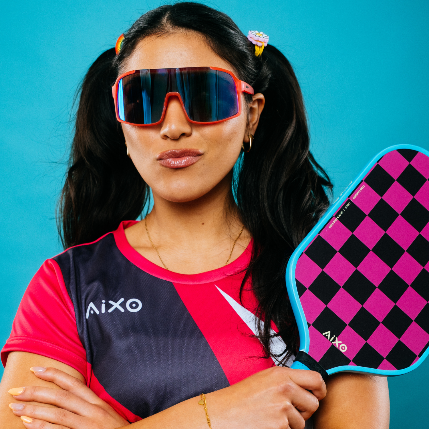Portrait of player showing off AIXO Ghost Dogtown paddle — bold checkerboard paddle with skater attitude.