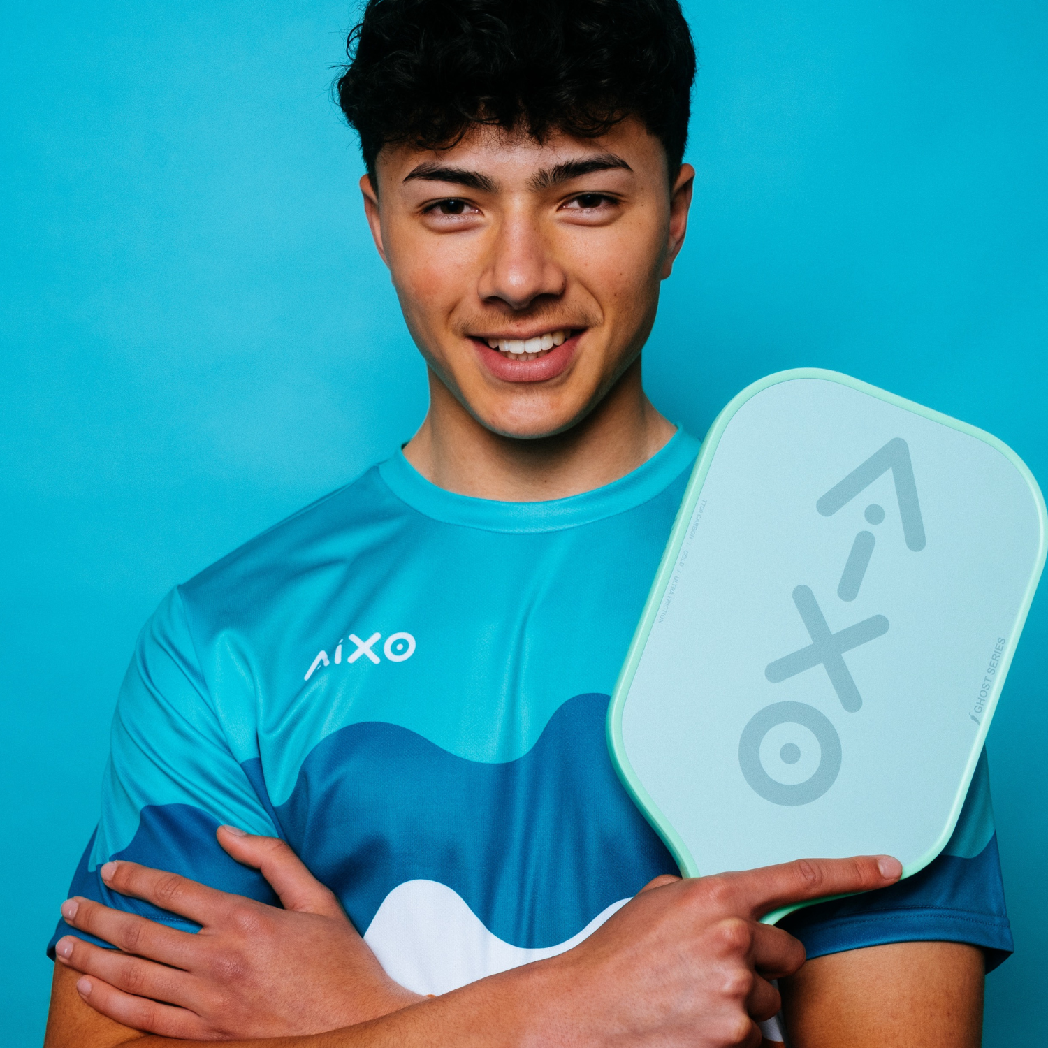 Player holding AIXO Ghost Pastel De Mint pickleball paddle — fresh design with effortless control.